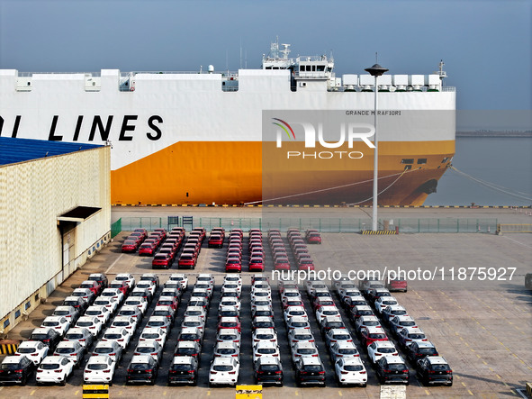 A ro-ro ship loads export vehicles at a port in Lianyungang, China, on December 18, 2024. 