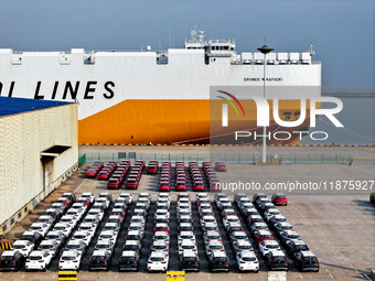 A ro-ro ship loads export vehicles at a port in Lianyungang, China, on December 18, 2024. (