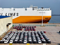 A ro-ro ship loads export vehicles at a port in Lianyungang, China, on December 18, 2024. (