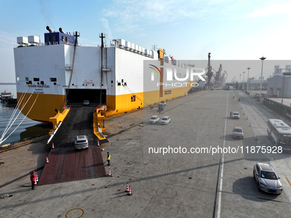 A ro-ro ship loads export vehicles at a port in Lianyungang, China, on December 18, 2024. 