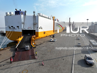 A ro-ro ship loads export vehicles at a port in Lianyungang, China, on December 18, 2024. (