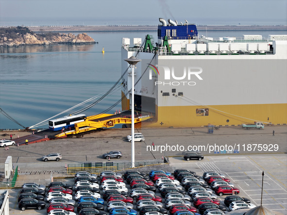 A ro-ro ship loads export vehicles at a port in Lianyungang, China, on December 18, 2024. 