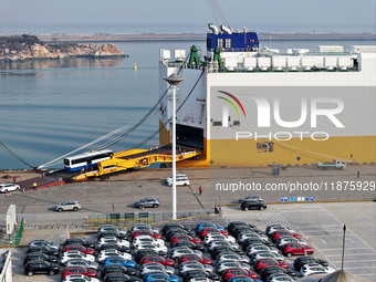 A ro-ro ship loads export vehicles at a port in Lianyungang, China, on December 18, 2024. (