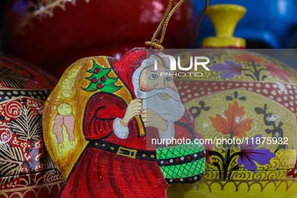 Christmas ornaments, including Santa Claus, are ready at the workshop before being sent to the market ahead of Christmas celebrations in Sri...