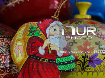 Christmas ornaments, including Santa Claus, are ready at the workshop before being sent to the market ahead of Christmas celebrations in Sri...