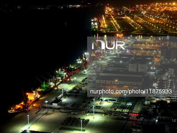 A photo taken on the evening of December 18, 2024, shows the working scene of the terminal at Lianyungang Port in Lianyungang, China, on Dec...