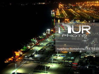 A photo taken on the evening of December 18, 2024, shows the working scene of the terminal at Lianyungang Port in Lianyungang, China, on Dec...