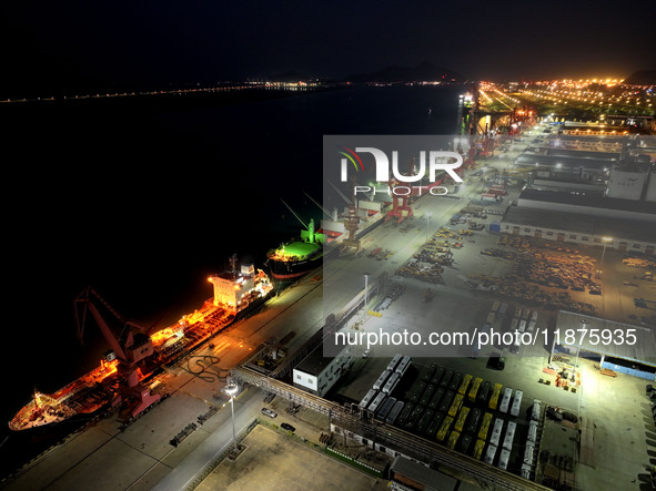 A photo taken on the evening of December 18, 2024, shows the working scene of the terminal at Lianyungang Port in Lianyungang, China, on Dec...