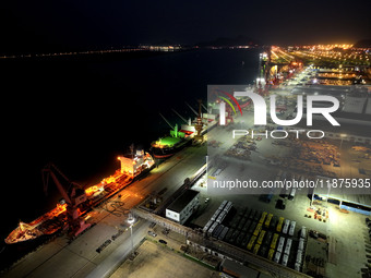 A photo taken on the evening of December 18, 2024, shows the working scene of the terminal at Lianyungang Port in Lianyungang, China, on Dec...