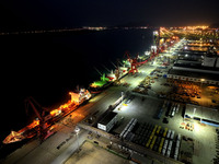 A photo taken on the evening of December 18, 2024, shows the working scene of the terminal at Lianyungang Port in Lianyungang, China, on Dec...