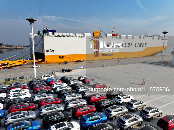 A ro-ro ship loads export vehicles at a port in Lianyungang, China, on December 18, 2024. 