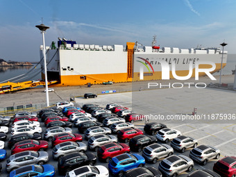 A ro-ro ship loads export vehicles at a port in Lianyungang, China, on December 18, 2024. (