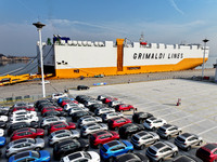 A ro-ro ship loads export vehicles at a port in Lianyungang, China, on December 18, 2024. (