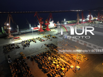 A photo taken on the evening of December 18, 2024, shows the working scene of the terminal at Lianyungang Port in Lianyungang, China, on Dec...