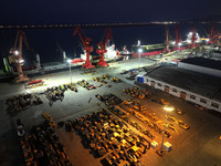 A photo taken on the evening of December 18, 2024, shows the working scene of the terminal at Lianyungang Port in Lianyungang, China, on Dec...