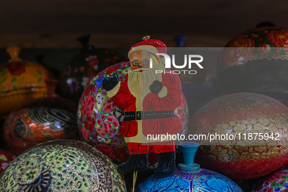 Christmas ornaments, including Santa Claus, are ready at the workshop before being sent to the market ahead of Christmas celebrations in Sri...