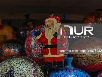 Christmas ornaments, including Santa Claus, are ready at the workshop before being sent to the market ahead of Christmas celebrations in Sri...