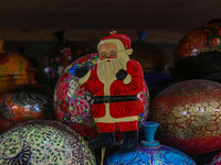 Christmas ornaments, including Santa Claus, are ready at the workshop before being sent to the market ahead of Christmas celebrations in Sri...