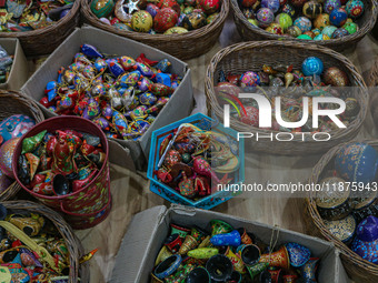 Christmas ornaments are ready at the workshop before being sent to the market ahead of Christmas celebrations in Srinagar, Jammu and Kashmir...