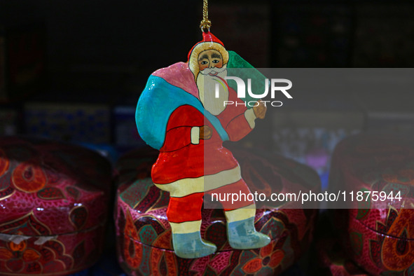 Christmas ornaments, including Santa Claus, are ready at the workshop before being sent to the market ahead of Christmas celebrations in Sri...