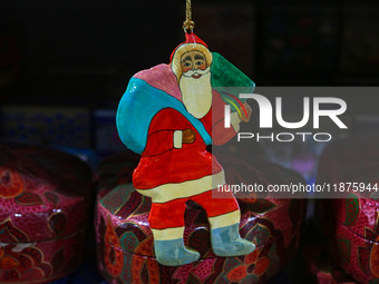 Christmas ornaments, including Santa Claus, are ready at the workshop before being sent to the market ahead of Christmas celebrations in Sri...