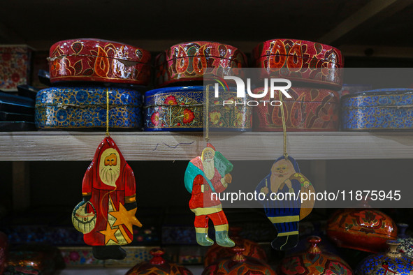 Christmas ornaments, including Santa Claus, are ready at the workshop before being sent to the market ahead of Christmas celebrations in Sri...