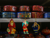 Christmas ornaments, including Santa Claus, are ready at the workshop before being sent to the market ahead of Christmas celebrations in Sri...