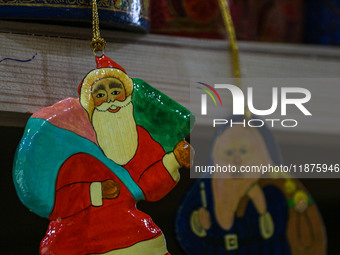 Christmas ornaments, including Santa Claus, are ready at the workshop before being sent to the market ahead of Christmas celebrations in Sri...