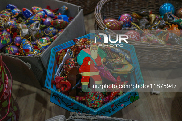 Christmas ornaments, including Santa Claus, are ready at the workshop before being sent to the market ahead of Christmas celebrations in Sri...