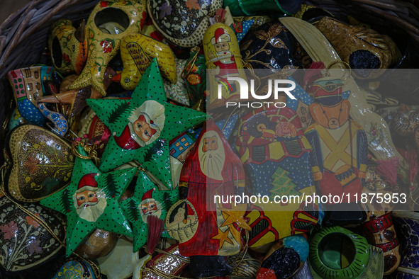 Christmas ornaments are ready at the workshop before being sent to the market ahead of Christmas celebrations in Srinagar, Jammu and Kashmir...