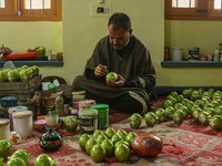 Fida Hussain Parray, a Kashmiri artisan, paints Christmas gift items at the workshop before sending them to the market ahead of Christmas ce...