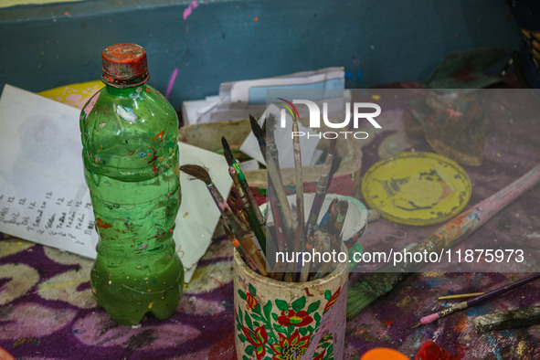 Brushes and colors used in papier-mache decoration are seen at the workshop in Srinagar, Jammu and Kashmir, on December 17, 2024. Artisans i...