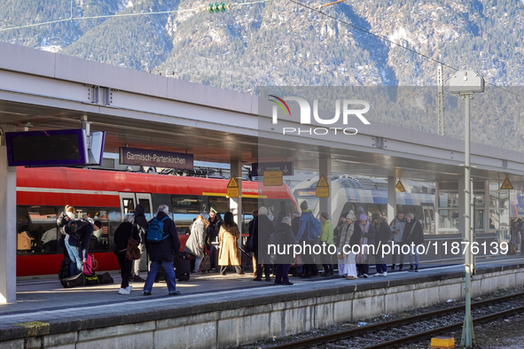 Travelers are at the Deutsche Bahn Regional Train Station in Garmisch-Partenkirchen, Bavaria, Germany, on December 13, 2024. 