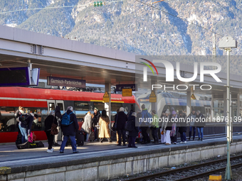 Travelers are at the Deutsche Bahn Regional Train Station in Garmisch-Partenkirchen, Bavaria, Germany, on December 13, 2024. (