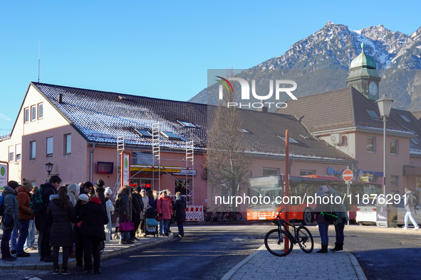 A busy winter day occurs at Garmisch-Partenkirchen Train Station in Bavaria, Germany, on December 13, 2024. Travelers gather at a bus stop n...