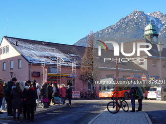 A busy winter day occurs at Garmisch-Partenkirchen Train Station in Bavaria, Germany, on December 13, 2024. Travelers gather at a bus stop n...