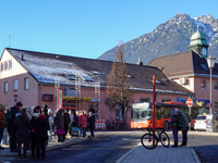 A busy winter day occurs at Garmisch-Partenkirchen Train Station in Bavaria, Germany, on December 13, 2024. Travelers gather at a bus stop n...