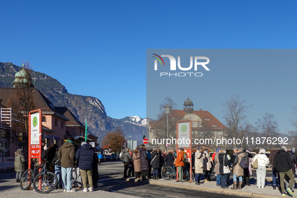 A busy winter day occurs at Garmisch-Partenkirchen Train Station in Bavaria, Germany, on December 13, 2024. Travelers gather at a bus stop n...