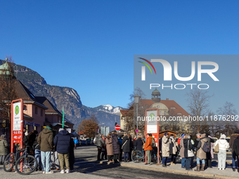 A busy winter day occurs at Garmisch-Partenkirchen Train Station in Bavaria, Germany, on December 13, 2024. Travelers gather at a bus stop n...