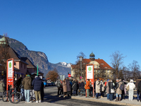 A busy winter day occurs at Garmisch-Partenkirchen Train Station in Bavaria, Germany, on December 13, 2024. Travelers gather at a bus stop n...