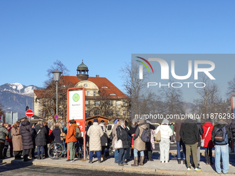 A busy winter day occurs at Garmisch-Partenkirchen Train Station in Bavaria, Germany, on December 13, 2024. Travelers gather at a bus stop n...