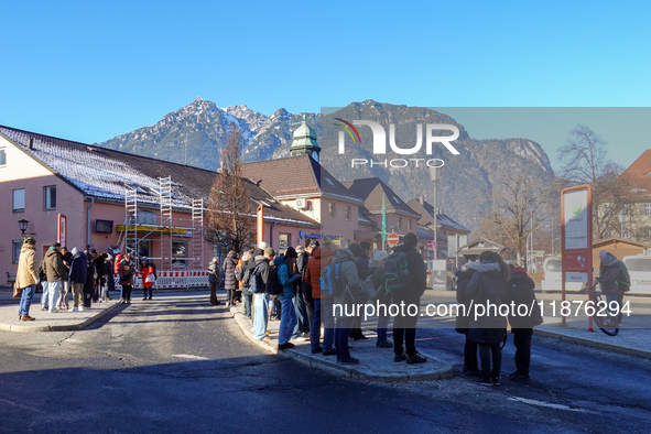 A busy winter day occurs at Garmisch-Partenkirchen Train Station in Bavaria, Germany, on December 13, 2024. Travelers gather at a bus stop n...