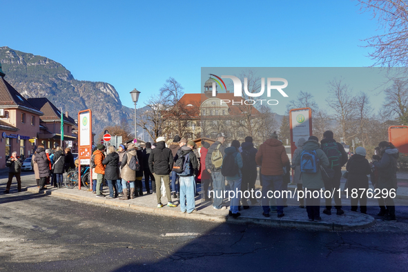 A busy winter day occurs at Garmisch-Partenkirchen Train Station in Bavaria, Germany, on December 13, 2024. Travelers gather at a bus stop n...