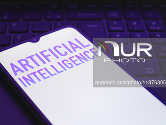 The text ''Artificial Intelligence (AI)'' appears on a smartphone screen in this illustration photo in Reno, United States, on December 17,...