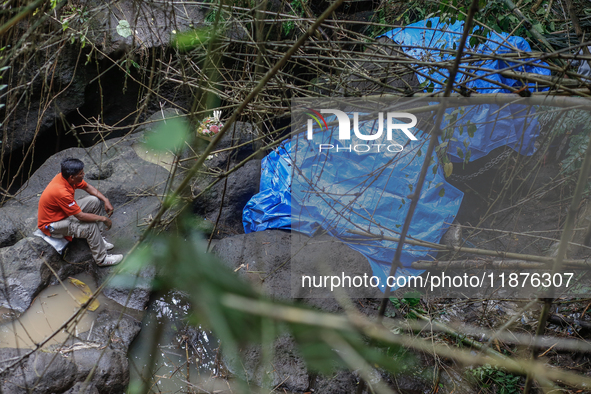 Officials observe the carcass of a 45-year-old female Sumatran elephant named Molly, found dead at a riverbank after being carried away by a...