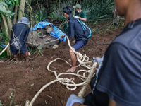 Workers and officials remove the carcass of a 45-year-old female Sumatran elephant named Molly, found dead at a riverbank after being carrie...