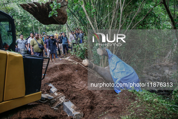 Workers and officials remove the carcass of a 45-year-old female Sumatran elephant named Molly, found dead at a riverbank after being carrie...