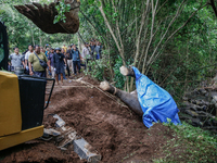 Workers and officials remove the carcass of a 45-year-old female Sumatran elephant named Molly, found dead at a riverbank after being carrie...