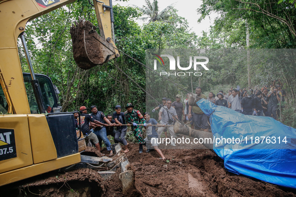 Workers and officials remove the carcass of a 45-year-old female Sumatran elephant named Molly, found dead at a riverbank after being carrie...