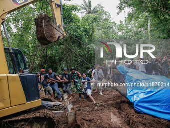 Workers and officials remove the carcass of a 45-year-old female Sumatran elephant named Molly, found dead at a riverbank after being carrie...